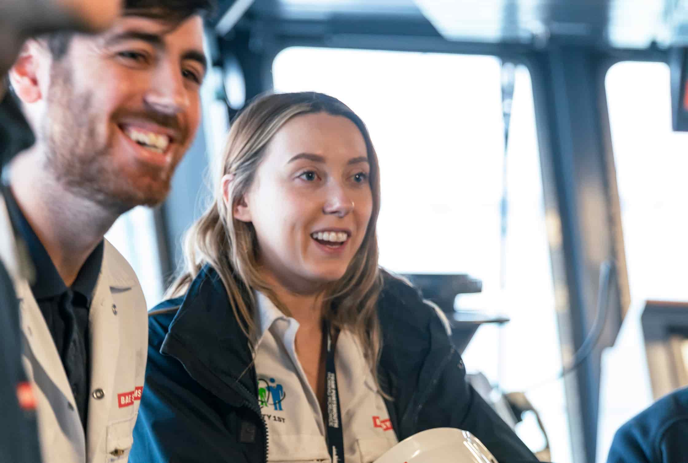 Employees smiling inside a ship