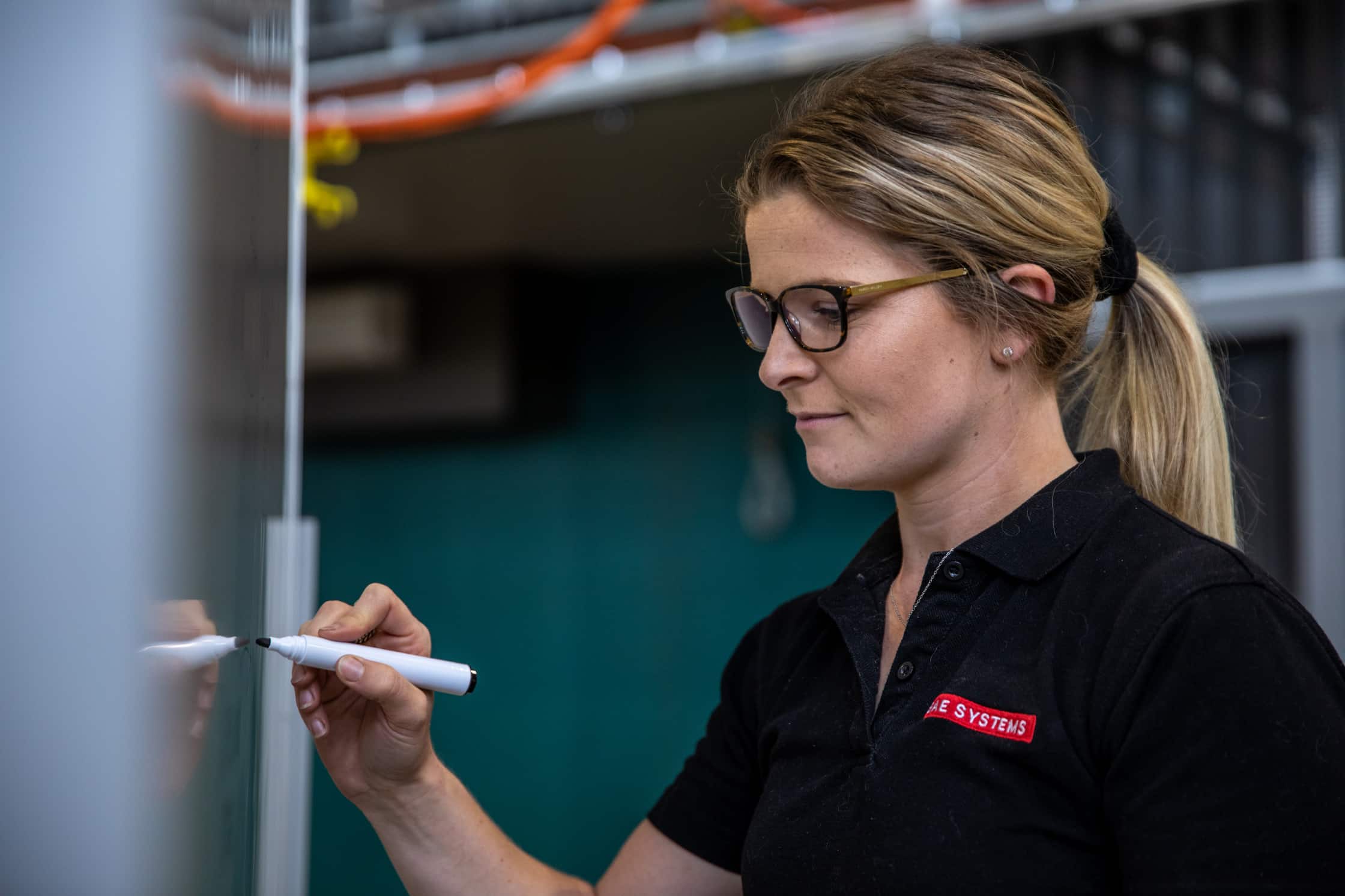 Woman writing on whiteboard