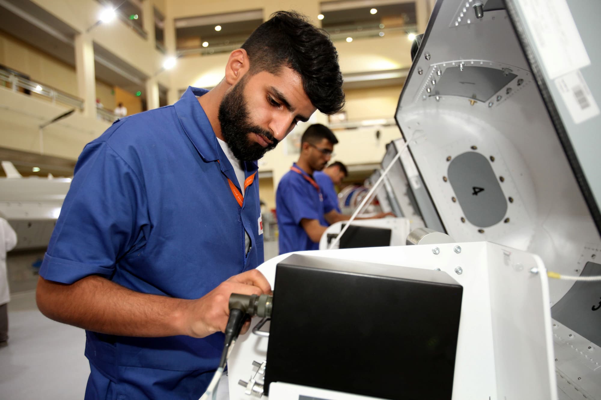 Young men focused on using advanced machinery 