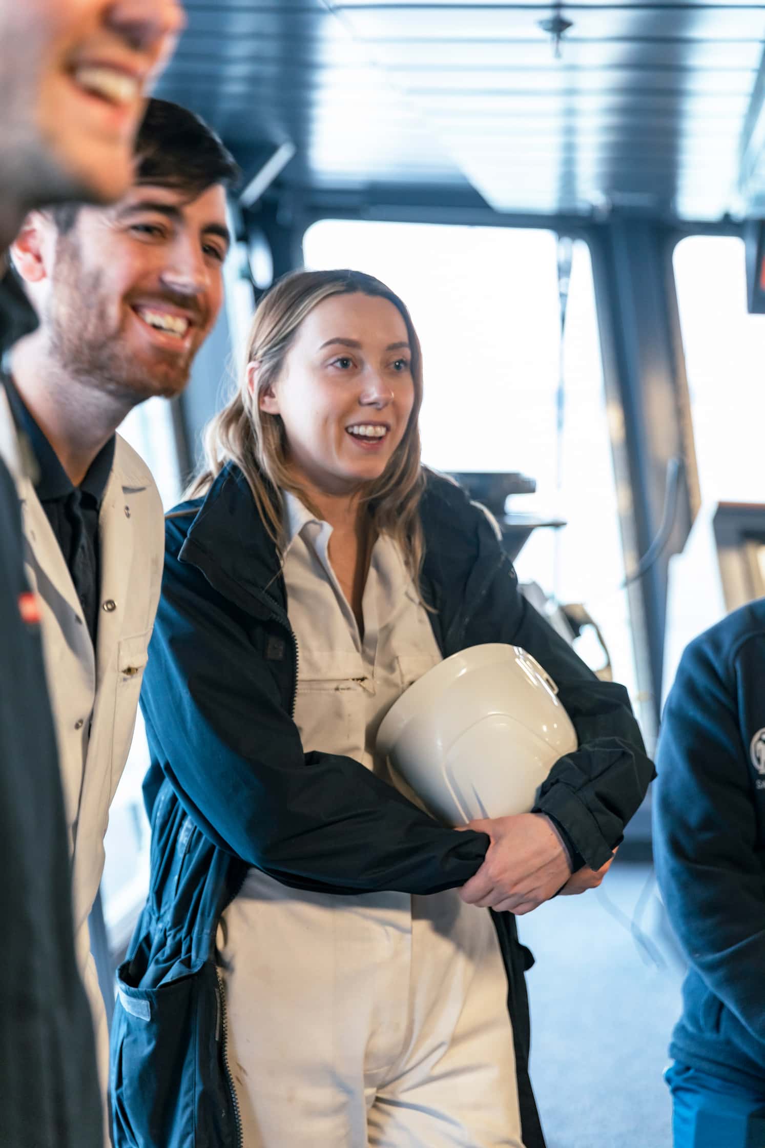 female employee holding helmet