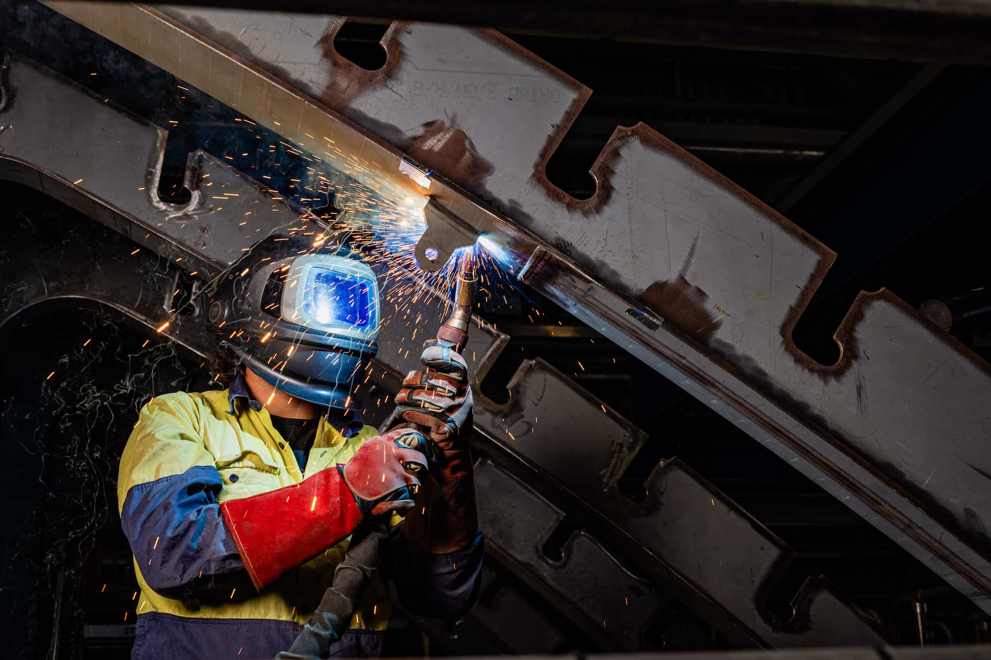 Welder wearing protective mask and gloves